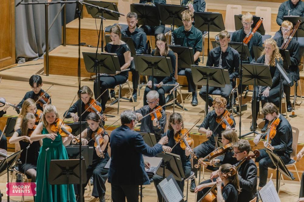 Orchestral musicians performing during a live concert at Moray Events venue, showcasing talented youth and adult musicians with professional stage setup in Moray, Scotland.