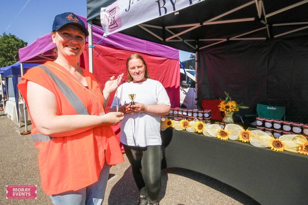 Bright outdoor scene at Moray Events, showcasing vibrant market stalls and local community engagement, perfect for promoting events and markets in Moray.